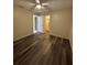 Bedroom featuring hardwood flooring, a ceiling fan, and a walk-in closet at 7601 Como Dr, New Port Richey, FL 34655