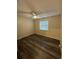 Bedroom featuring new wood floors, a modern ceiling fan, and a bright window at 7601 Como Dr, New Port Richey, FL 34655