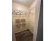Walk-in closet with shelves and hanging rods, providing ample storage space in the home at 7601 Como Dr, New Port Richey, FL 34655