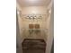 Walk-in closet with ample storage shelving and hardwood flooring at 7601 Como Dr, New Port Richey, FL 34655