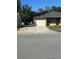 Exterior view of home showing attached garage, neutral paint and driveway at 7601 Como Dr, New Port Richey, FL 34655