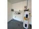 Garage space featuring a modern water heater, shelving, and ample storage solutions at 7601 Como Dr, New Port Richey, FL 34655