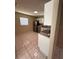 A bright kitchen featuring tile flooring and white cabinets at 7601 Como Dr, New Port Richey, FL 34655