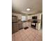 Modern kitchen with stainless steel appliances, ample white cabinetry, and tile flooring at 7601 Como Dr, New Port Richey, FL 34655