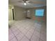 The open living area boasts tile flooring, neutral walls, and a ceiling fan at 7601 Como Dr, New Port Richey, FL 34655