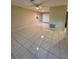 The spacious living room showcases tile flooring, neutral paint, and a ceiling fan at 7601 Como Dr, New Port Richey, FL 34655