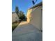 Home exterior featuring a long, concrete driveway and low-maintenance side yard at 7601 Como Dr, New Port Richey, FL 34655