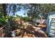 Fenced backyard featuring mature trees, space for outdoor activities, and room for gardening and entertaining at 769 53Rd N Ter, St Petersburg, FL 33703