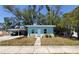 View of a light blue single-story home with a front yard and trees, offering a cozy curb appeal at 769 53Rd N Ter, St Petersburg, FL 33703