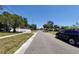 Quiet residential street with homes and mature trees on a sunny day at 769 53Rd N Ter, St Petersburg, FL 33703