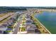 Beautiful aerial view of community homes surrounding a tranquil lake on a sunny day at 7782 Sail Clover Ln, Zephyrhills, FL 33540