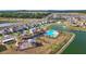 Scenic aerial view highlighting the community pool, lake, playground, and well-placed homes at 7782 Sail Clover Ln, Zephyrhills, FL 33540