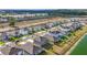 Serene aerial view of the neighborhood homes near a peaceful lake and a lush green landscape at 7782 Sail Clover Ln, Zephyrhills, FL 33540