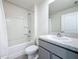 Bathroom featuring a shower, tub, granite vanity and sink at 7782 Sail Clover Ln, Zephyrhills, FL 33540