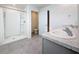 Modern bathroom featuring double sinks, granite countertops, and a walk-in shower with tiled floors at 7782 Sail Clover Ln, Zephyrhills, FL 33540