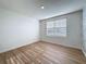 This bedroom has wood-look flooring, natural light and a decorative accent wall at 7782 Sail Clover Ln, Zephyrhills, FL 33540
