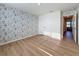 This bedroom has wood-look flooring, natural light and a closet at 7782 Sail Clover Ln, Zephyrhills, FL 33540