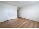 This bedroom has wood-look flooring, natural light and a closet at 7782 Sail Clover Ln, Zephyrhills, FL 33540