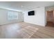Bright bedroom with a window and modern flooring, along with a mounted TV for entertainment at 7782 Sail Clover Ln, Zephyrhills, FL 33540
