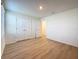 This bedroom has wood-look flooring, natural light from the window and a closet at 7782 Sail Clover Ln, Zephyrhills, FL 33540