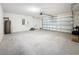 Spacious garage with concrete floors, equipped with a modern garage door system at 7782 Sail Clover Ln, Zephyrhills, FL 33540