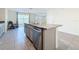 Kitchen island featuring stainless appliances, granite countertops, and views of the outdoor lake at 7782 Sail Clover Ln, Zephyrhills, FL 33540