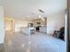 Kitchen featuring an island, stainless steel appliances, ceramic tile floors, and modern lighting at 7782 Sail Clover Ln, Zephyrhills, FL 33540