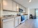 Kitchen featuring granite countertops, stainless appliances, and light wood cabinetry at 7782 Sail Clover Ln, Zephyrhills, FL 33540