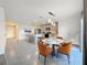Bright eat-in kitchen features an island with seating, stainless steel appliances, and a modern pendant light at 7782 Sail Clover Ln, Zephyrhills, FL 33540