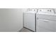 Bright laundry room featuring white washer and dryer units against a neutral wall at 7782 Sail Clover Ln, Zephyrhills, FL 33540