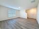 Spacious open-plan living room with hardwood floors and a large window for natural light at 7782 Sail Clover Ln, Zephyrhills, FL 33540