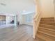 Spacious living room area with new hardwood floors and easy access to kitchen and stairs at 7782 Sail Clover Ln, Zephyrhills, FL 33540