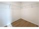 Walk-in closet featuring wire shelving and wood-look floors, providing ample storage space at 7782 Sail Clover Ln, Zephyrhills, FL 33540