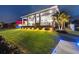Backyard with extensive green lawn, palm trees, and large covered patio at 813 Manns Harbor Dr, Apollo Beach, FL 33572