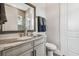 Bright bathroom featuring a marble vanity top, bronze fixtures and stylish mirror at 813 Manns Harbor Dr, Apollo Beach, FL 33572