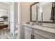 Bright bathroom with marble countertop vanity and framed mirror at 813 Manns Harbor Dr, Apollo Beach, FL 33572