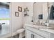 Bright half bathroom featuring modern vanity with marble countertop and shiplap walls at 813 Manns Harbor Dr, Apollo Beach, FL 33572