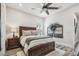 Bedroom features a wood bed frame, nightstand, and decorative wall art at 813 Manns Harbor Dr, Apollo Beach, FL 33572