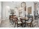 Stately dining room featuring long wood table, wood floors and hanging decorative chandeliers at 813 Manns Harbor Dr, Apollo Beach, FL 33572