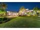 Expansive lawn highlights this home's exterior, complete with lush landscaping, palm trees and a multi-car garage at 813 Manns Harbor Dr, Apollo Beach, FL 33572