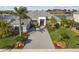 Stunning waterfront home boasts lush landscaping, a spacious driveway, and a grand entrance at 813 Manns Harbor Dr, Apollo Beach, FL 33572