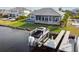 Exterior view of the home featuring a private boat dock and swimming pool at 813 Manns Harbor Dr, Apollo Beach, FL 33572