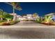An evening view of the home's front exterior showcasing professionally landscaped garden beds at 813 Manns Harbor Dr, Apollo Beach, FL 33572