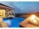 View of an infinity pool with fire feature overlooking a beautiful waterfront at twilight at 813 Manns Harbor Dr, Apollo Beach, FL 33572