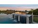 View of an infinity pool with flowing waterfalls and fire feature overlooking a beautiful waterfront at 813 Manns Harbor Dr, Apollo Beach, FL 33572
