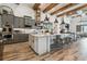 Gourmet kitchen with stainless steel appliances, center island, and wood beam accents at 813 Manns Harbor Dr, Apollo Beach, FL 33572