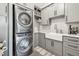Spacious laundry room featuring stacked washer and dryer, sink and ample counter space at 813 Manns Harbor Dr, Apollo Beach, FL 33572