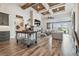 Open-concept living room with beamed ceilings, a stone fireplace, and sliding doors to outdoor views at 813 Manns Harbor Dr, Apollo Beach, FL 33572