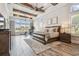Spacious primary bedroom with wood floors, ceiling beams, and waterfront views at 813 Manns Harbor Dr, Apollo Beach, FL 33572