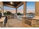 Well-appointed outdoor kitchen with built-in grill, stainless steel appliances, and counter space for culinary creations at 813 Manns Harbor Dr, Apollo Beach, FL 33572